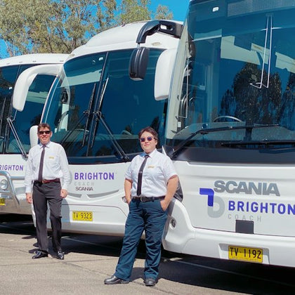Brighton Coach drivers standing in front of the luxury coaches.