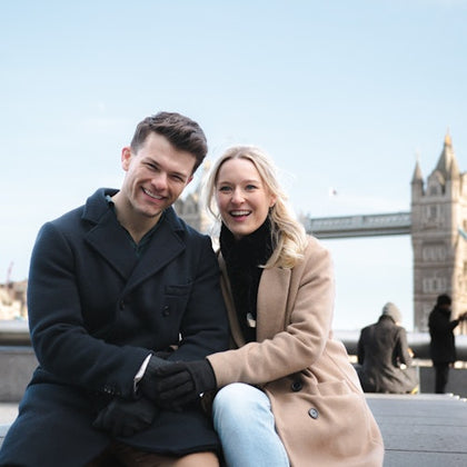 A couple enjoying their photoshoot in front of the iconic Tower Bridge