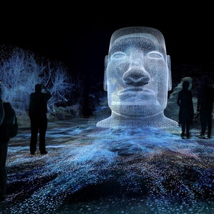 A glowing wireframe sculpture of a head is displayed in a dark setting with silhouettes of people observing it.