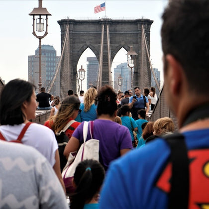A memorable photo of the tour group as they walk across the iconic Brooklyn Bridge.