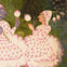 A stylized painting of two figures in a garden, dressed in lotus petal-like garments, holding and surrounded by flowers.