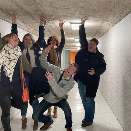 Guests enjoy a fun group photo inside the rustic tunnel during the Astroville Tunnel Tour of Downtown Houston.