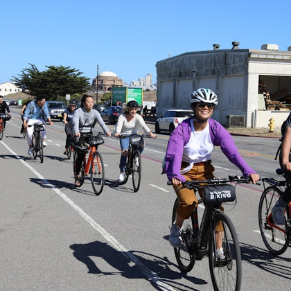 A group of friends ride through San Francisco