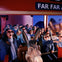 People wearing 3D glasses enjoy an indoor ride with a donkey character in front, background features mountains and lights. "FAR FAR" sign visible.