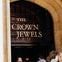 People entering an arched doorway with a sign that reads "The Crown Jewels."