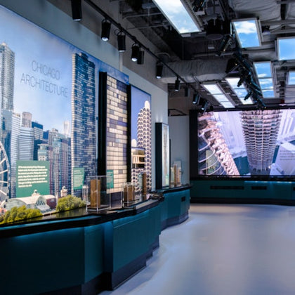 Exhibit showcasing Chicago architecture with large photographs, models of buildings, and informational displays in a modern space.