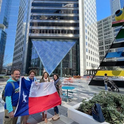 Guests pose for a group photo in front of the tallest building in Texas 