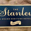 A sign reading 'The Stanley, A Grand Heritage Hotel, Since 1909' on a stone background.