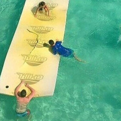 Chilling with water toys, the scene radiates joy as friends soak up the sun—a vibrant moment of carefree fun by the water.