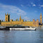A boat labeled 'Uber Boat by Thames Clippers' on a river with the Houses of Parliament and Big Ben in the background.