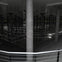 A dimly lit underground space with numerous columns and reflective surfaces, featuring intersecting light patterns.