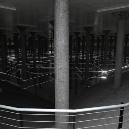 A dimly lit underground space with numerous columns and reflective surfaces, featuring intersecting light patterns.