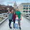 Family standing on bridge