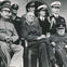 Several military and political leaders in uniform posing together for a group photo on a balcony.