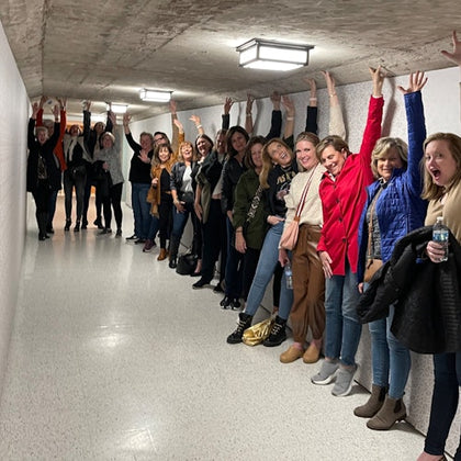 Guests enjoy a fun group photo inside the rustic tunnel during the Astroville Tunnel Tour of Downtown Houston