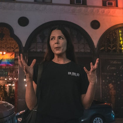 Tour guide expressing with her hands while telling a story to her group
