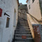 A concrete staircase between two buildings with a sign at the bottom reading "Area Closed for Your Safety."