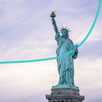 The Statue of Liberty holding a torch, viewed from below, with a curved green line overlaying the image against a cloudy sky.