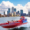 A red speedboat labeled "Thames Rockets" with passengers in safety gear, set against a cityscape and a partly cloudy sky.