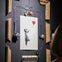 A shredded artwork depicting a girl with a red balloon, surrounded by a dismantled frame and wires, with a viewer observing.