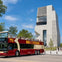 A red double-decker tour bus labeled "Big Bus Chicago" parked near a modern building with geometric architecture.
