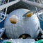 A large spherical structure with suspended planet models, including Saturn and Jupiter, in a modern exhibition setting.