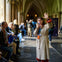 A tour guide speaking to a seated group in a historic building with vaulted ceilings and Gothic architecture.