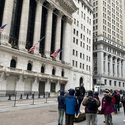 An engaging shot of our tour group captivated by the rich history of the New York Stock Exchange.