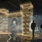 A digital representation of a castle gate with illuminated outlines and animal figures, viewed by two people in a dark room.