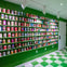 A wall with shelves displaying an assortment of colorful cans in a room with green and white checkered flooring.