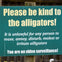 Sign reads: "Please be kind to the alligators! It is unlawful for any person to tease, annoy, disturb, molest or irritate alligators. You are on video surveillance!"