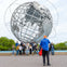 Group shot with guide taking the photo at Unisphere in Brooklyn, Bronx, Queens Tour