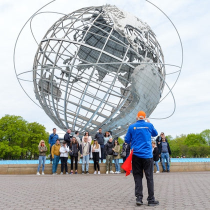 Group shot with guide taking the photo at Unisphere in Brooklyn, Bronx, Queens Tour