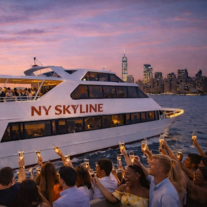 People raising glasses on a boat labeled 'NY Skyline,' with a city skyline and sunset in the background.