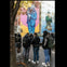 A captivating photo of our tour guest standing in front of an iconic painting in Harlem.