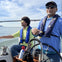 father and son on enjoying a cruise on a calm day