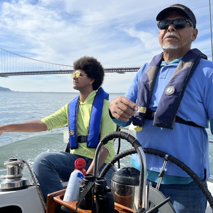 father and son on enjoying a cruise on a calm day