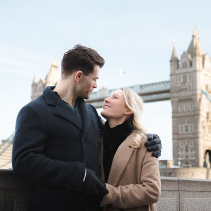 A couple enjoying their photoshoot in front of the iconic Tower Bridge