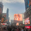 Open top double decker tour bus approaching Yonge-Dundas Square. Multiple billboard and TV screens showing advertising. 