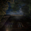 Nighttime photo of the House of Death in New York with a spooky clouds overhead