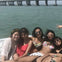 Group gathered at the boat's edge—a snapshot of shared moments and boundless camaraderie against the open waters.