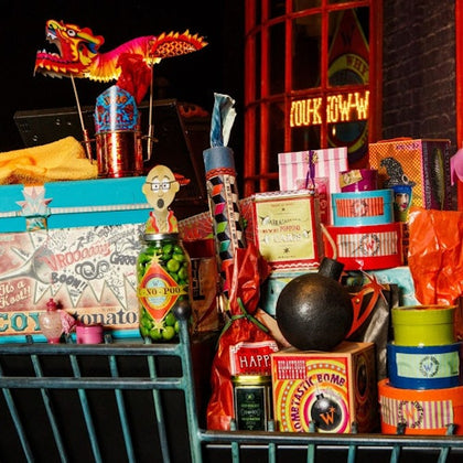 A collection of colorful items, including boxes, jars, and decorations, displayed in a vibrant and festive arrangement.