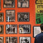 A museum display featuring black-and-white photos of The Beatles, with a person viewing the exhibit.