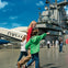 Children walking and pointing on the deck of the Intrepid Sea, Air & Space Museum, with aircraft and the ship's structure visible.