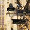 Signs reading "The Roman Baths" hanging near an ornate building facade with stained glass and sculptures.