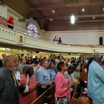 A snapshot of a tour guest immersed in the uplifting atmosphere of a Sunday church service.