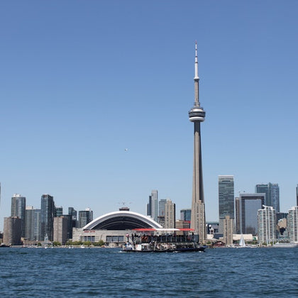 The Harbour Star cruising the inner Toronto Harbour. Toronto skyline in the background showing the CN Tower and Rogers Centre