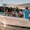 A GoBoat sailing with four guests onboard sharing stories over a bottle of wine 