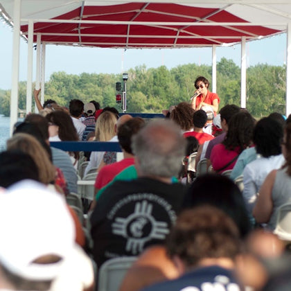Tour guide giving tour on upper level of boat