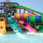 Colorful water slides and people enjoying them at a water park.